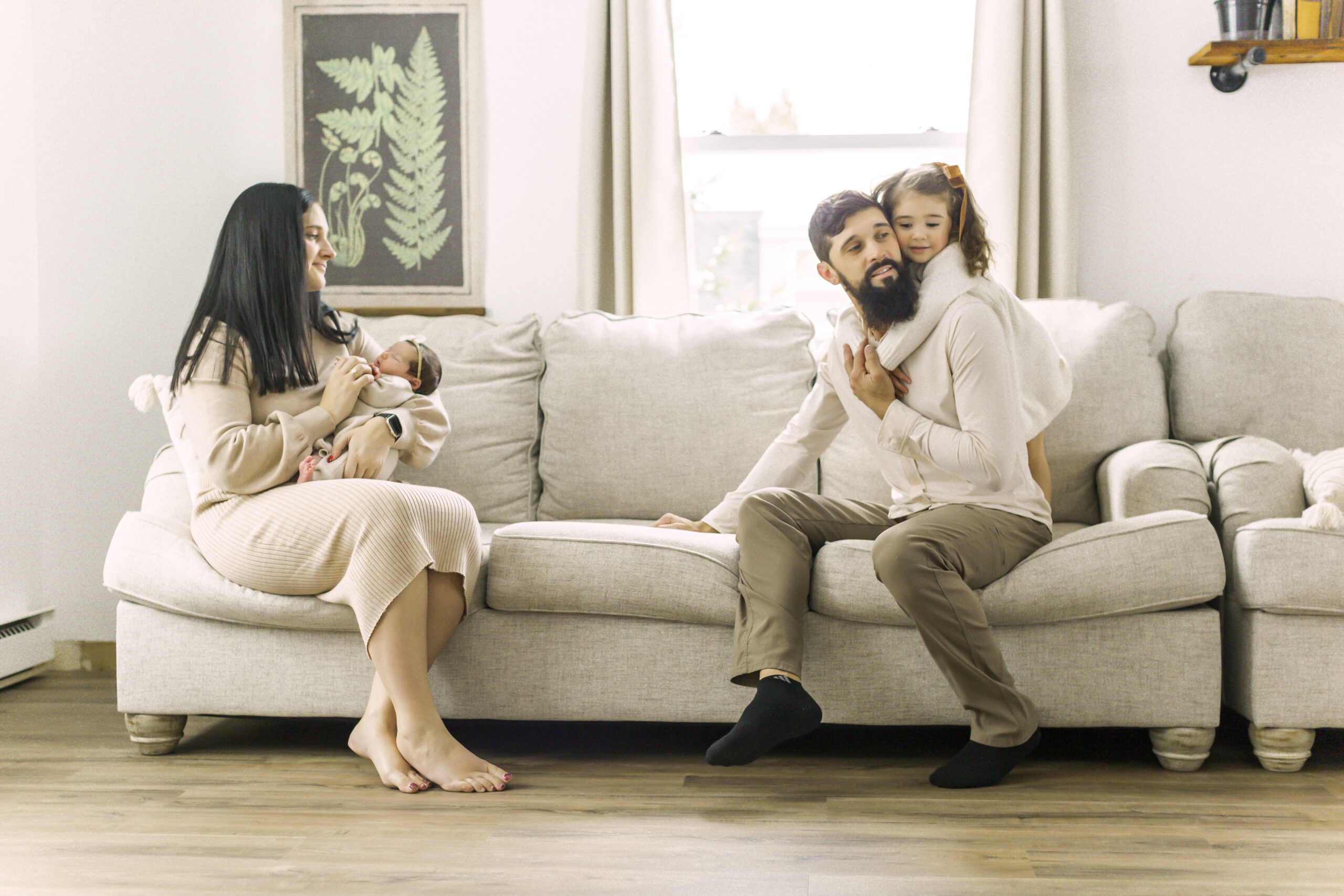 in home family session couch toddler newborn mom and dad